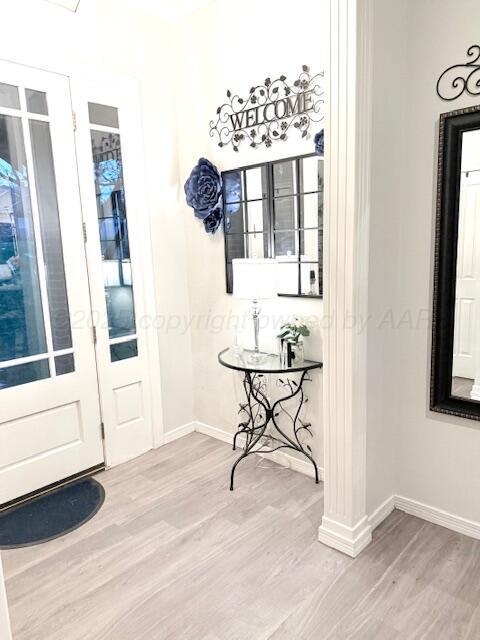 interior space featuring baseboards and wood finished floors