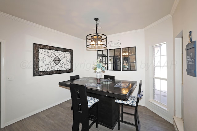dining room with baseboards, ornamental molding, dark wood finished floors, and a chandelier