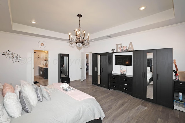 bedroom featuring recessed lighting, a chandelier, a tray ceiling, and dark wood-style floors