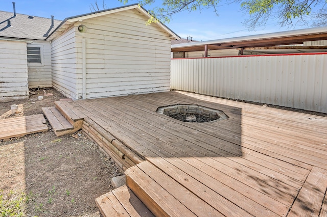 wooden terrace with an outdoor fire pit