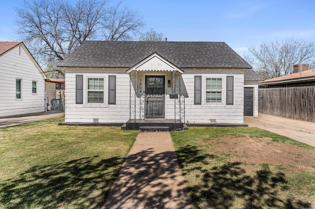 bungalow-style house featuring a shingled roof, a front yard, and fence