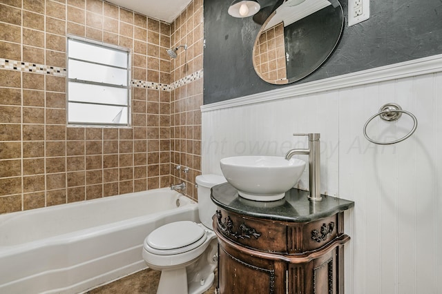 bathroom with toilet, shower / tub combination, vanity, and wainscoting