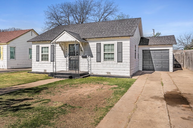 bungalow featuring a garage, a front yard, fence, a shingled roof, and concrete driveway