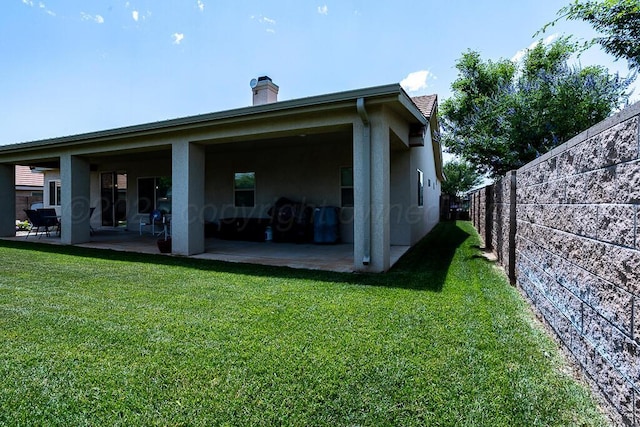 1006 Pinot Blvd, Amarillo, TX 79124 - rear view of house featuring a patio, a chimney, and stucco siding