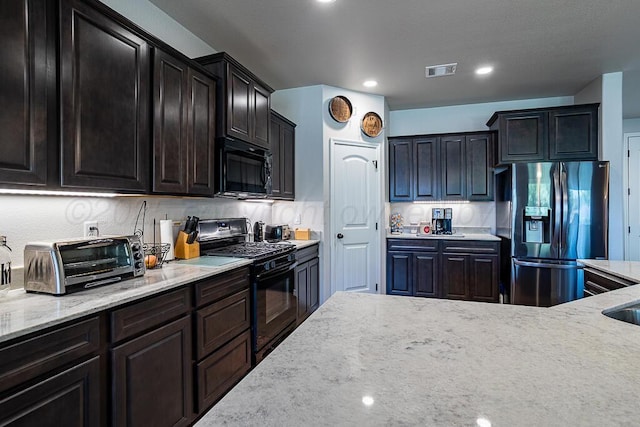 1006 Pinot Blvd, Amarillo, TX 79124 - kitchen featuring black appliances, light stone counters, and recessed lighting