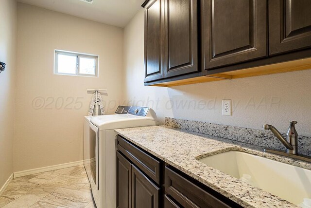 1006 Pinot Blvd, Amarillo, TX 79124 - laundry room with cabinet space, light marble finish flooring, and washer and clothes dryer