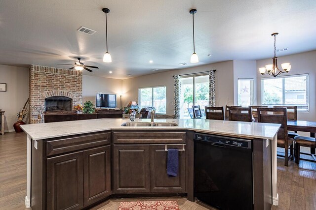 1006 Pinot Blvd, Amarillo, TX 79124 - kitchen with black dishwasher, open floor plan, ceiling fan, light wood finished floors, and a fireplace