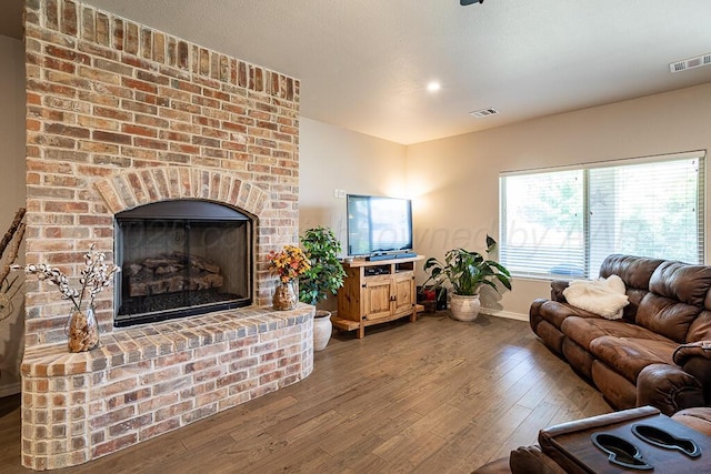 1006 Pinot Blvd, Amarillo, TX 79124 - living area featuring hardwood / wood-style floors and a brick fireplace