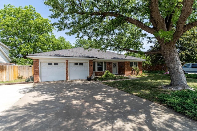 4903 Princeton St, Amarillo, TX 79109 - ranch-style house with concrete driveway, brick siding, and a garage