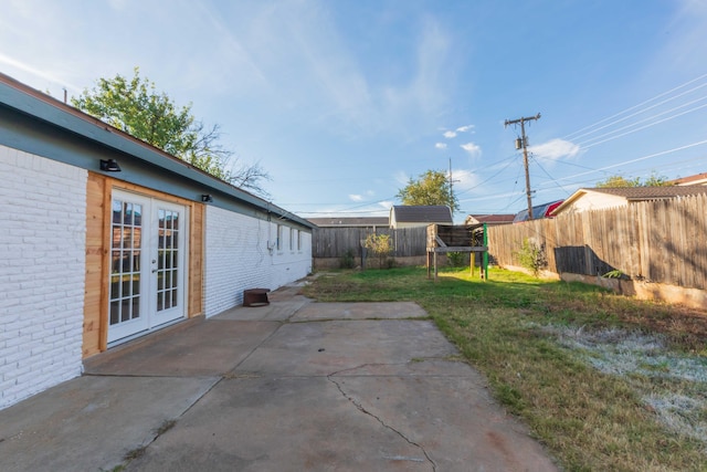 view of yard with french doors and a patio