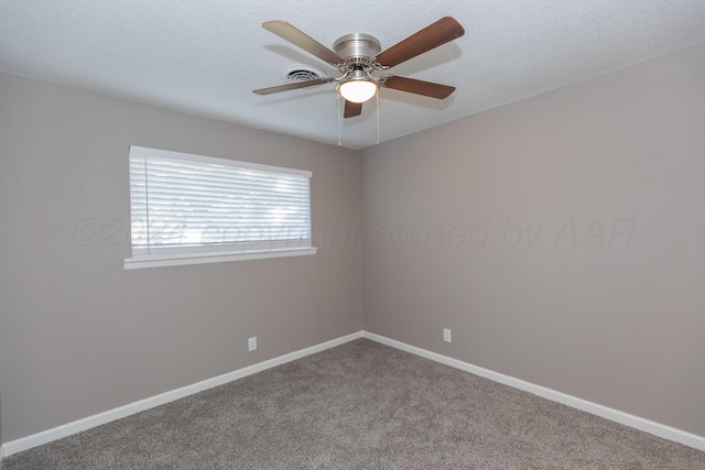 empty room featuring carpet flooring, ceiling fan, and a textured ceiling