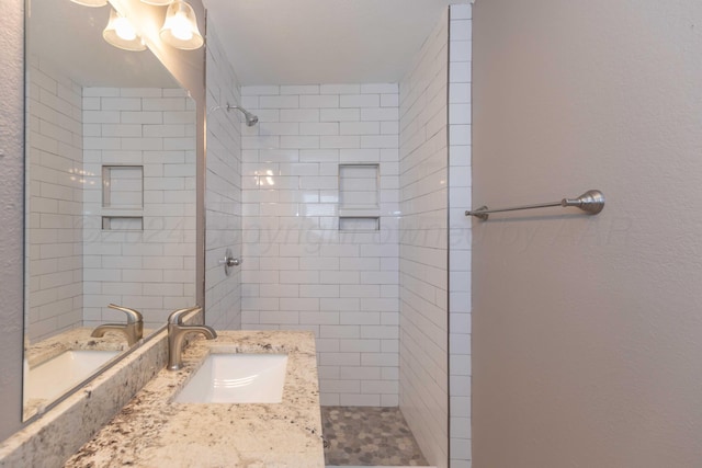 bathroom featuring vanity and tiled shower