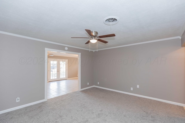 unfurnished room featuring light carpet, french doors, ceiling fan, and crown molding