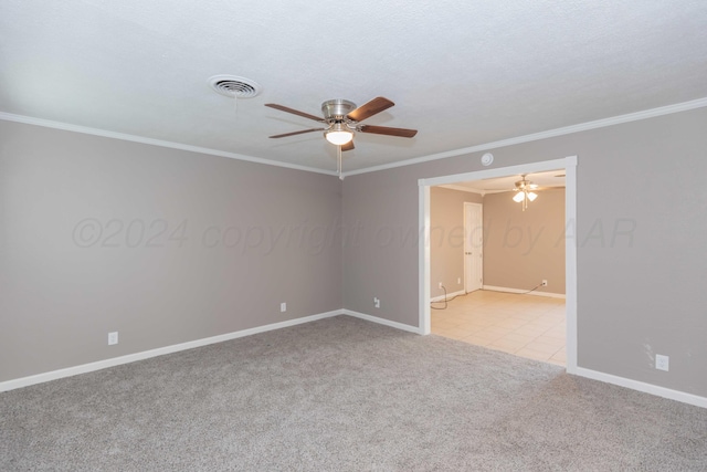 unfurnished room with a textured ceiling, ceiling fan, ornamental molding, and light carpet