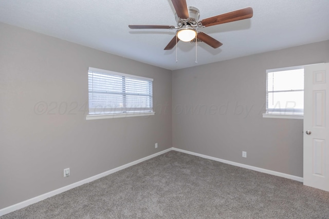 carpeted spare room with ceiling fan