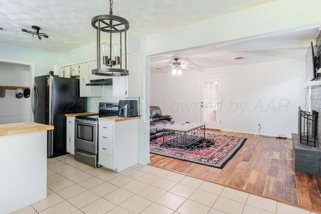 5210 S Milam St, Amarillo, TX 79110 - kitchen featuring appliances with stainless steel finishes, butcher block counters, ceiling fan, backsplash, and light tile patterned floors