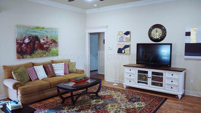 living area with ceiling fan, baseboards, crown molding, and wood finished floors