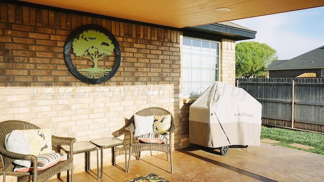 view of patio featuring grilling area and fence