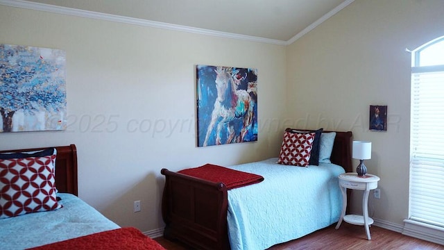 bedroom with baseboards, wood finished floors, and crown molding