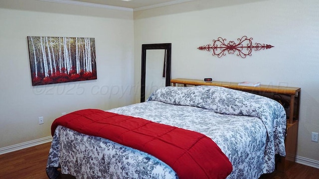 bedroom featuring wood finished floors, baseboards, and crown molding