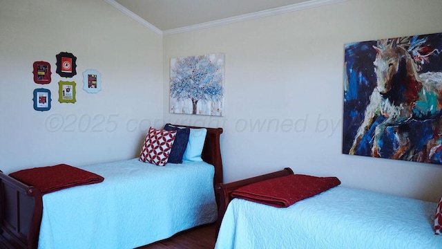 bedroom with wood finished floors and crown molding
