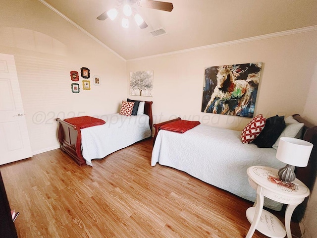 bedroom with visible vents, lofted ceiling, wood finished floors, ceiling fan, and ornamental molding