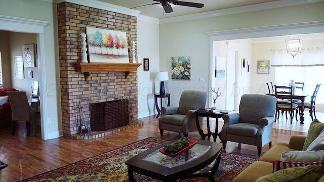 living room with wood finished floors, a healthy amount of sunlight, and crown molding