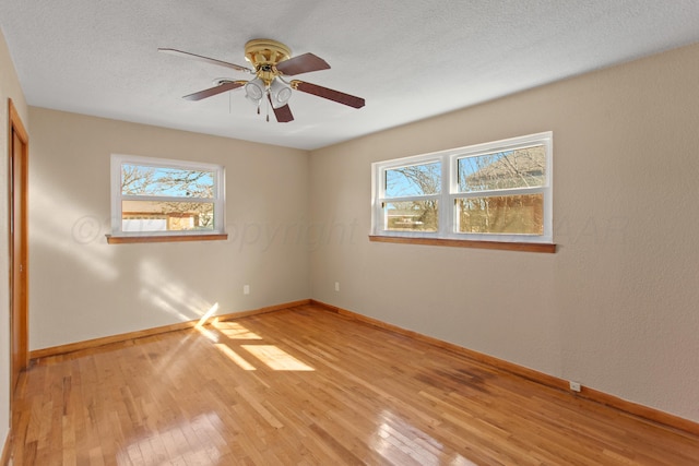 unfurnished bedroom with light wood finished floors, multiple windows, and baseboards