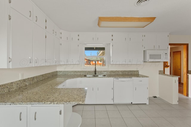 kitchen featuring white appliances, a sink, visible vents, white cabinetry, and light stone countertops