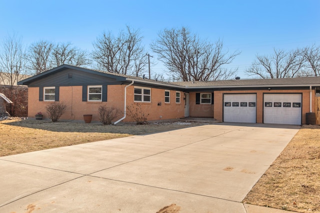 ranch-style house with a garage, brick siding, and driveway