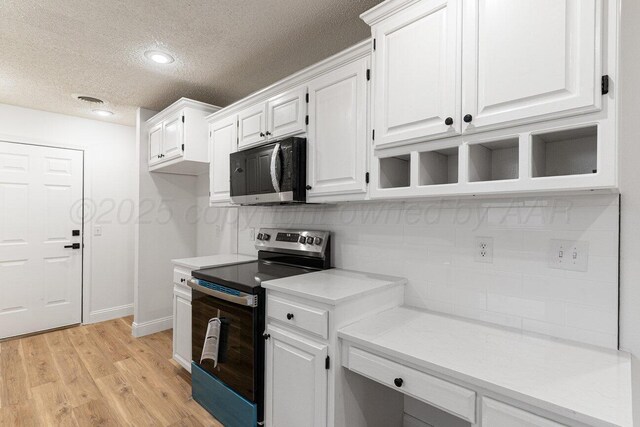 2607 15th Ave, Canyon, TX 79015 - kitchen featuring stainless steel electric stove, a textured ceiling, light countertops, white cabinetry, and tasteful backsplash