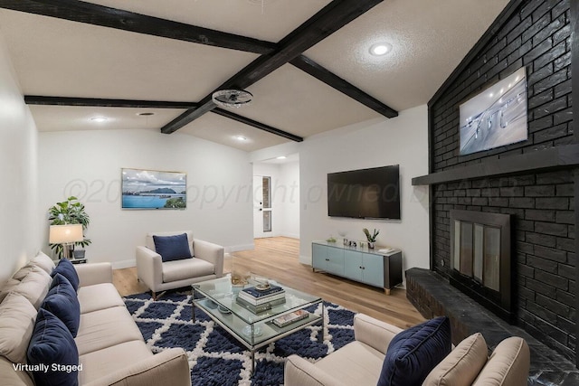 2607 15th Ave, Canyon, TX 79015 - living room featuring wood finished floors, a brick fireplace, baseboards, and recessed lighting