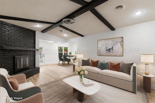 2607 15th Ave, Canyon, TX 79015 - living room featuring light wood finished floors, baseboards, a textured ceiling, recessed lighting, and a fireplace