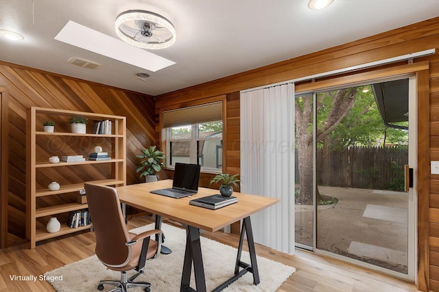 2607 15th Ave, Canyon, TX 79015 - office area with a skylight, light wood finished floors, and wood walls