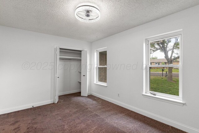 2607 15th Ave, Canyon, TX 79015 - unfurnished bedroom with carpet floors, a textured ceiling, a closet, and baseboards