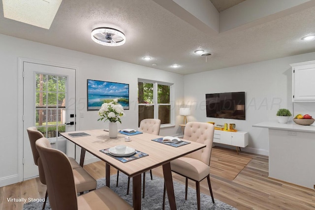 2607 15th Ave, Canyon, TX 79015 - dining room featuring a textured ceiling, light wood-style floors, healthy amount of natural light, and baseboards