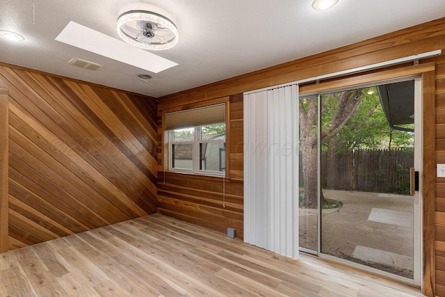 2607 15th Ave, Canyon, TX 79015 - spare room with a skylight, wood walls, and wood finished floors