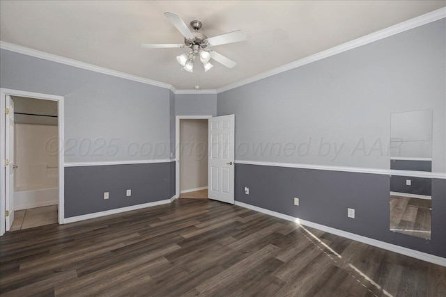 unfurnished bedroom featuring baseboards, ornamental molding, ensuite bathroom, wood finished floors, and a ceiling fan