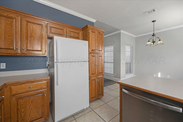 kitchen featuring visible vents, freestanding refrigerator, stainless steel dishwasher, crown molding, and brown cabinets