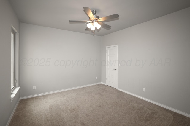 carpeted spare room featuring ceiling fan