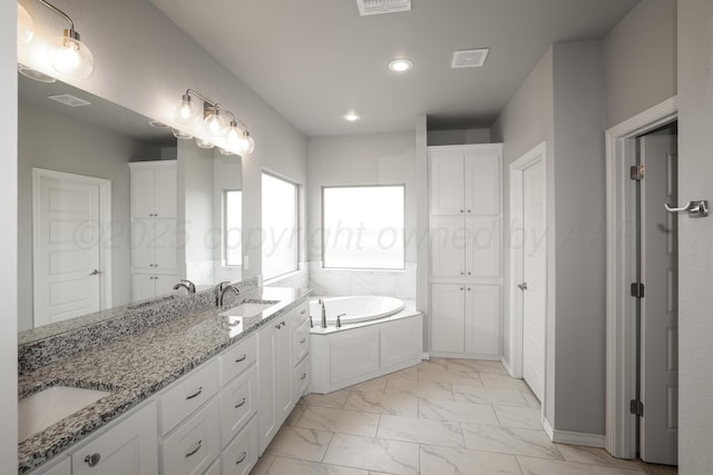 bathroom featuring vanity and a tub