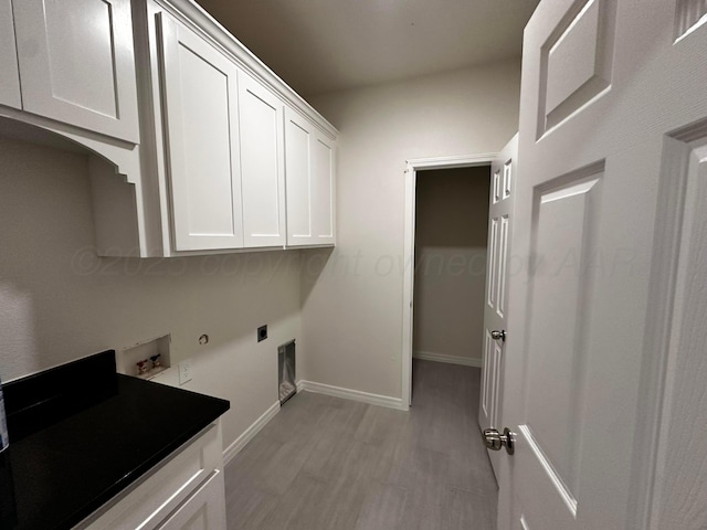 1513 SE 11th Ave, Amarillo, TX 79102 - washroom featuring cabinet space, hookup for an electric dryer, light wood-style floors, hookup for a washing machine, and gas dryer hookup
