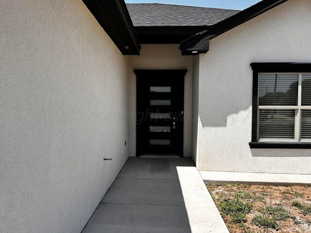 1513 SE 11th Ave, Amarillo, TX 79102 - property entrance with stucco siding and roof with shingles