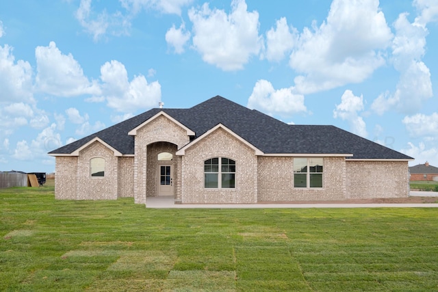 french country style house with a front lawn