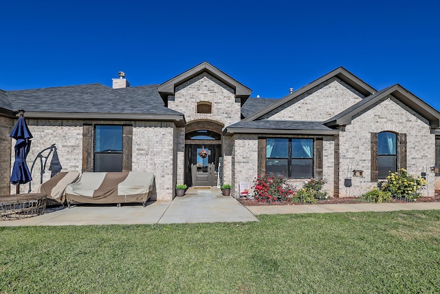 french country style house featuring a front yard