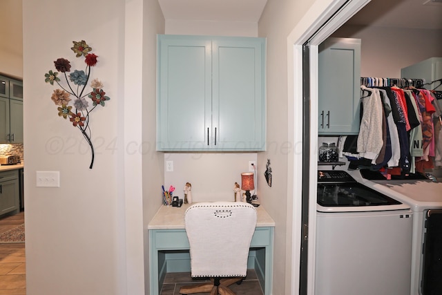 clothes washing area featuring washing machine and dryer, cabinets, and hardwood / wood-style flooring