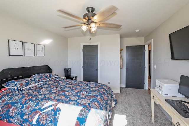 carpeted bedroom with ensuite bathroom and ceiling fan