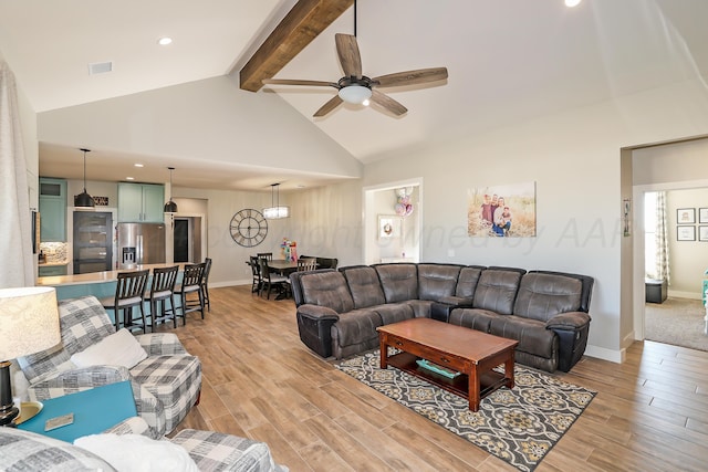 living room with beam ceiling, high vaulted ceiling, light hardwood / wood-style flooring, and ceiling fan