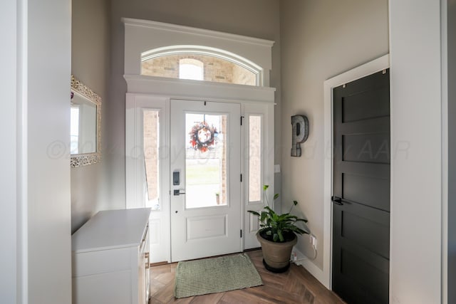 foyer entrance with parquet flooring