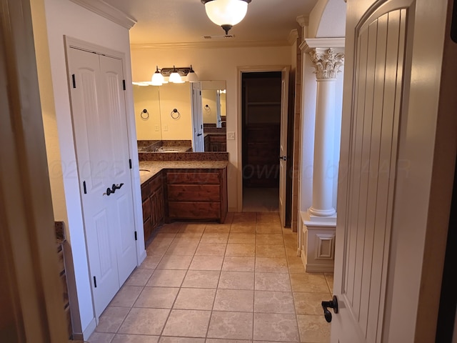 bathroom with tile patterned flooring, crown molding, vanity, and ornate columns